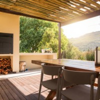 barbecue and dining table on a rustic patio on a sunny afternoon - garden decoration stock pictures, royalty-free photos & images