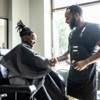 barber cutting young boys hair in barbershop - hairstyle stock pictures, royalty-free photos & images