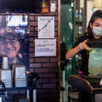 Bartender Brianna Van De Mortel packs up food to-go at Kelly's Korner on Saturday, May 16, 2020 in Placentia, CA. The sports bar is effectively...