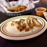 basket of bone in deep fried wings with discards after eating - junk food stock pictures, royalty-free photos & images