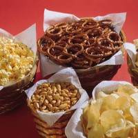 baskets of assorted snacks - junk food stockfoto's en -beelden