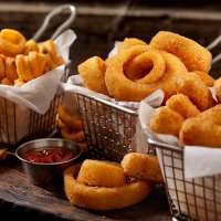 baskets of onion rings, curly fries and cheese sticks - junk food stock pictures, royalty-free photos & images