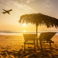 beach at a tropical resort at sunset and a flying plane. summer vacation on tropical resort - home decoration stock pictures, royalty-free photos & images
