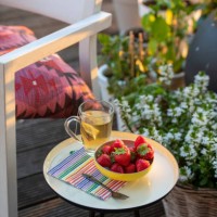 beakfast of tea and strawberries on a beautiful table in the summer sunshine garden and herbs in full bloom, flowers - garden decoration photos et images de collection