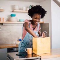 beautiful african-american woman preparing to eat her ordered food - junk food stock pictures, royalty-free photos & images