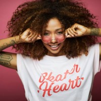 beautiful afro caribbean young woman in summer clothes against pink background. - fashion stock pictures, royalty-free photos & images