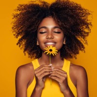beautiful afro woman with a flower - fashion stock pictures, royalty-free photos & images