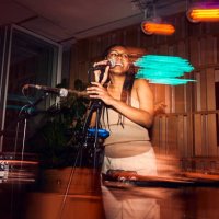 beautiful black girl talking into microphone during live jazz show - concert stock pictures, royalty-free photos & images