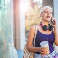 beautiful blonde young woman talking on smartphone - junk food stock pictures, royalty-free photos & images