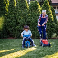 beautiful boy having fun with grandmother in the garden - garden decoration stock pictures, royalty-free photos & images