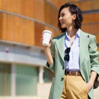 beautiful businesswoman with hand in pocket holding reusable coffee cup - junk food stock pictures, royalty-free photos & images