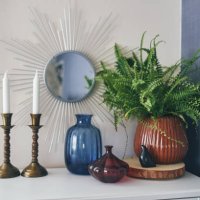 beautiful design of a white shelf or nightstand. candles, a mirror and green flower, glass vase - home decoration stock pictures, royalty-free photos & images