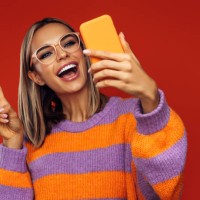 beautiful emotional woman using smart phone - fashion stock pictures, royalty-free photos & images