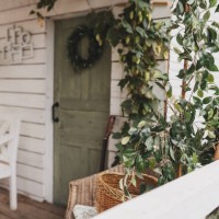 beautiful porch home with autumn decorations on thanksgiving. garden table and chairs with apples and pumpkins on autumn yard. terrace with retro light bulbs garlands. halloween. interior cozy patio - garden decoration stock 