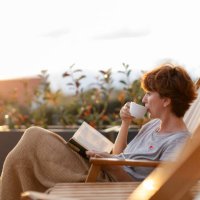 beautiful woman enjoying on patio at home - coffee stockfoto's en -beelden