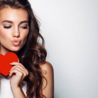 beautiful woman holding artificial heart - hairstyle stock pictures, royalty-free photos & images