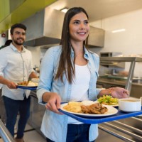 beautiful woman leaving the buffet service with her tray ready to eat lunch - food stock pictures, royalty-free photos & images