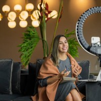 beautiful woman performing a live from home while using her ring of light to illuminate herself and her cell phone to make the video - fashion stock pictures, royalty-free photos & images