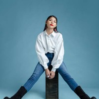 beautiful woman sitting in front of plain background - fashion stock pictures, royalty-free photos & images