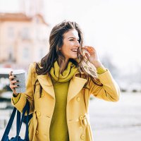 beautiful woman walking outdoors on a sunny day - junk food stock pictures, royalty-free photos & images
