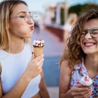 beautiful women eating ice cream in walk - food stock pictures, royalty-free photos & images