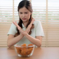 beautiful young asian woman refuses to eat junk food or fast food. - junk food stock pictures, royalty-free photos & images