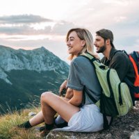 beautiful young couple relaxing after hiking and taking a break - travel stock pictures, royalty-free photos & images