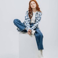 beautiful young model posing sitting in studio on cube white background casual new clothes catalog. fashion and trend concept - fashion stock pictures, royalty-free photos & images