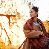 beautiful young woman enjoying a carefree autumn day outdoors - fashion stock pictures, royalty-free photos & images