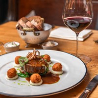 beef deer steak filet with fried sweetbread and gravy served with red wine at michelin star gourmet restaurant - food stock pictures, royalty-free photos & images