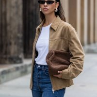 Bella Emar wears Levi’s blue denim jeans, white Cos t-shirt, brown Massimo Dutti Jacket during the Berlin Fashion Week SS25 on July 01, 2024 in...