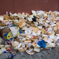 Big pile of garbage, mostly from fast-food packaging, lies on a street during the annual Notting Hill Carnival.