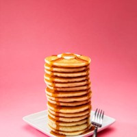 big tall stack of pancakes on pink background - food stock pictures, royalty-free photos & images