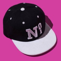 black and white baseball cap with text 'no 1', on pink background. concept of fashion, clothing, accessories, hip hop, baseball, sport, uniform and sun protection. - fashion stock pictures, royalty-free photos & images