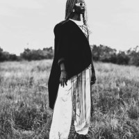 black and white photography. beautiful woman in suit and jacket outdoors. authentic style. summer fashion. model with afro hairstyle. stylish accessories. earrings. - fashion stock pictures, royalty-free photos & images