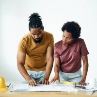 black couple examining blueprints during home renovation process. - home decoration stock pictures, royalty-free photos & images