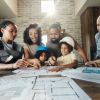 black family and manual workers analyzing blueprints at home. - home decoration stock pictures, royalty-free photos & images
