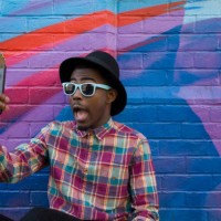 black man taking selfie near colorful wall - fashion stock pictures, royalty-free photos & images