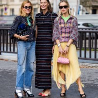 Blanca Miro Scrimieri wears denim jeans, black jacket, bag Maria de la Orden wears striped dress outside Chanel & Monica Anoz wears yellow pleated...