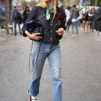 Blanca Miro wears sunglasses, a green scarf, a tweed knit jacket, a black striped Chanel bag, ripped jeans, white socks, high heels shoes, outside...
