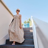 blond woman moving down steps outside cafe under blue sky - fashion stock pictures, royalty-free photos & images