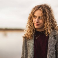blonde curly girl in coat outdoors - fashion stock pictures, royalty-free photos & images