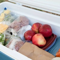 blue igloo cooler, filled with picnic food - food stock pictures, royalty-free photos & images
