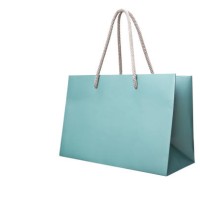 blue paper shopping bag isolated on white - fashion stock-fotos und bilder