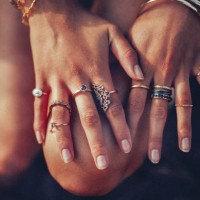 boho girl's hands looking feminine with many rings - fashion stock pictures, royalty-free photos & images