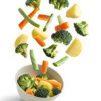 boiled vegetables flying on white background. creative concept - food stock pictures, royalty-free photos & images