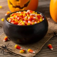 bowl of halloween candy corns and jack o' lantern - home decoration stock pictures, royalty-free photos & images