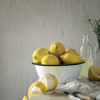 bowl with fresh lemons for making lemonade on a wooden table on a background of light textured concrete wall - home decoration stock pictures, royalty-free photos & images