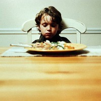boy alone at dinner table, not eating - food stock pictures, royalty-free photos & images