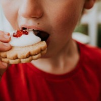 boy eating a german biscuit - food stock pictures, royalty-free photos & images